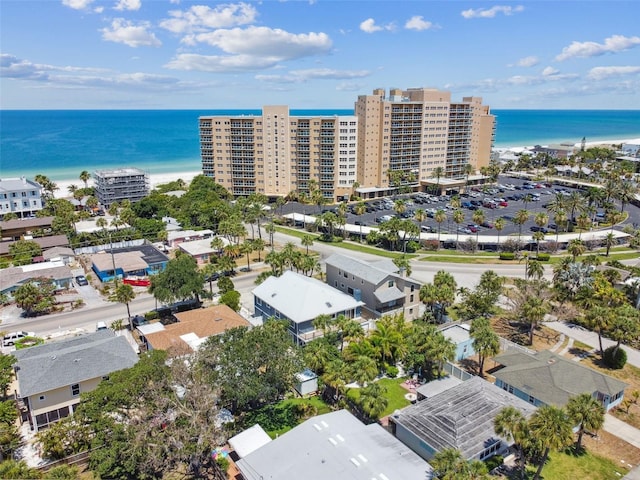 bird's eye view featuring a water view and a beach view