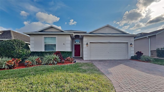 ranch-style home with a garage and a front lawn