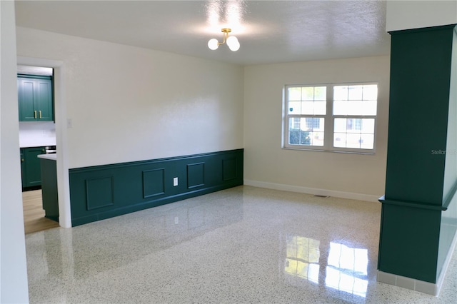 spare room featuring a textured ceiling