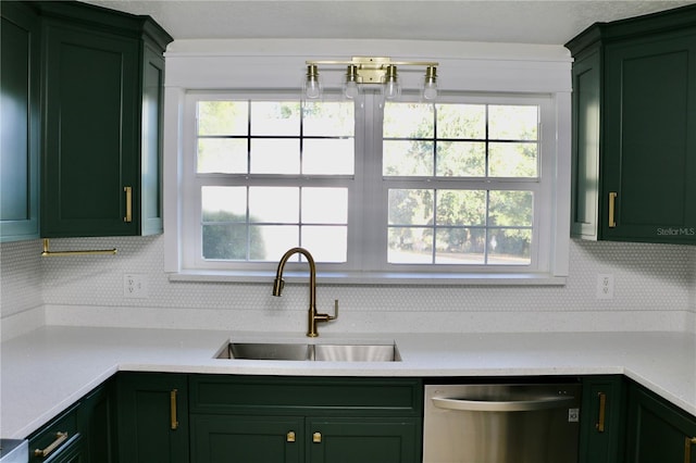 kitchen featuring sink, backsplash, green cabinetry, and dishwasher