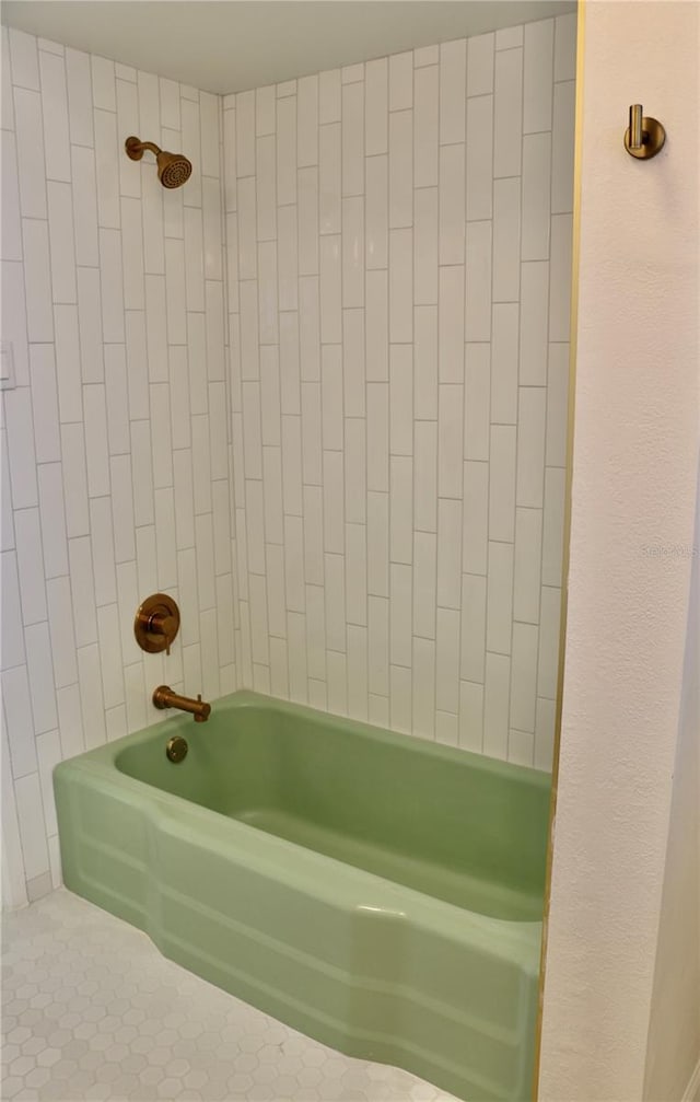 bathroom featuring tiled shower / bath and tile patterned flooring