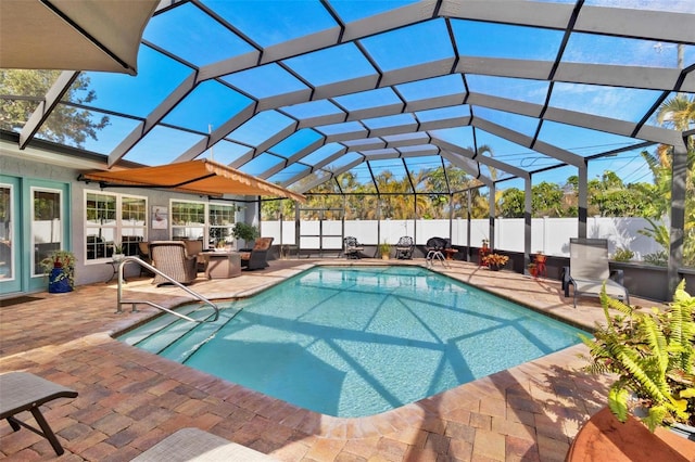 view of swimming pool featuring a patio, an outdoor hangout area, and glass enclosure