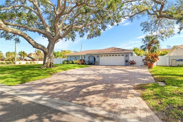 ranch-style home featuring a garage and a front lawn