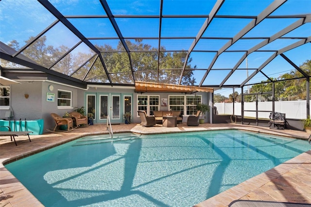 view of swimming pool featuring an outdoor hangout area, a patio area, and glass enclosure