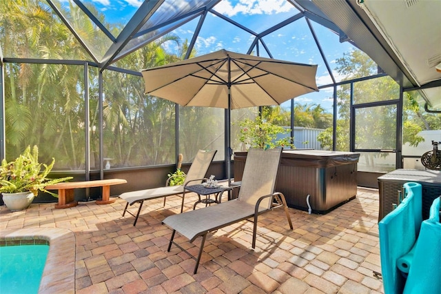 view of patio / terrace with a hot tub and a lanai