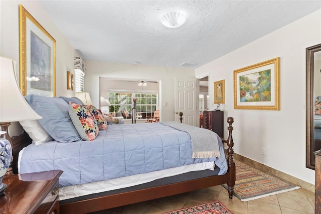 bedroom featuring light tile patterned floors and a textured ceiling