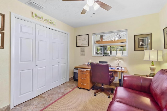 office space with a textured ceiling and ceiling fan