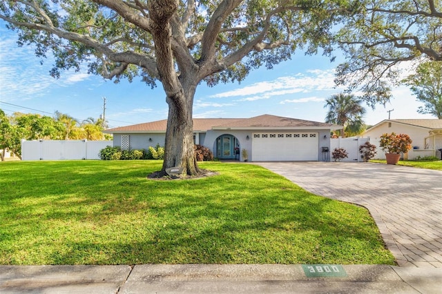 ranch-style home with a garage and a front yard