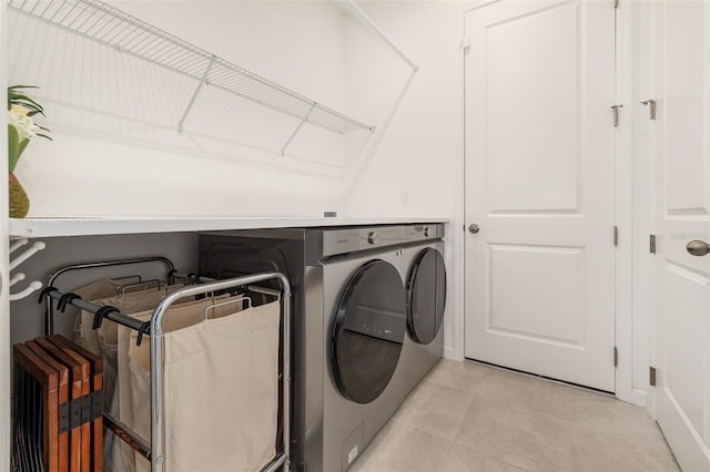 laundry area featuring light tile patterned floors and independent washer and dryer