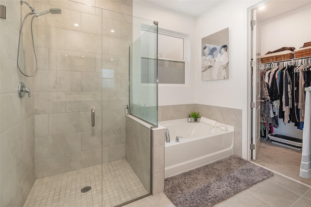 bathroom with tile patterned floors and independent shower and bath