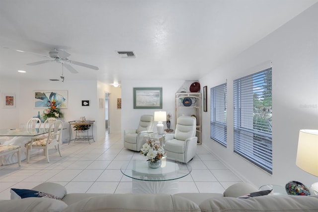 tiled living room with ceiling fan