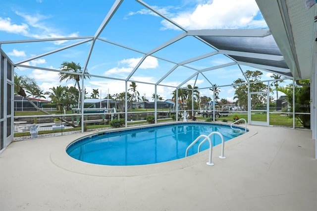 view of swimming pool with a lanai and a patio area