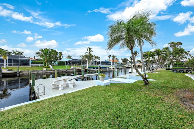 dock area with a water view and a yard