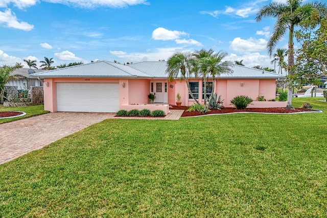 single story home featuring a garage and a front yard