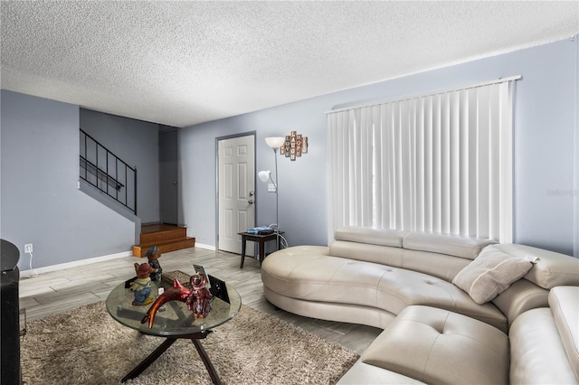 living room featuring light hardwood / wood-style floors and a textured ceiling