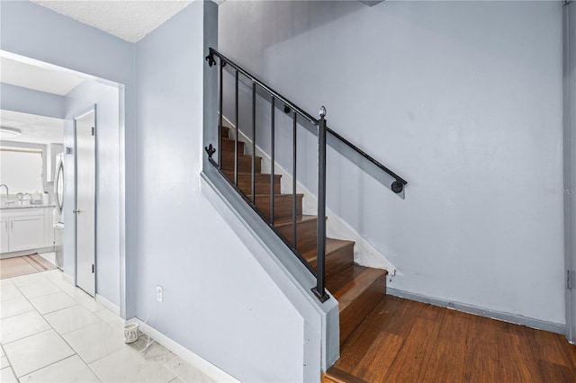 stairway featuring tile patterned floors