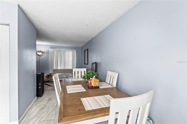 dining space with a textured ceiling