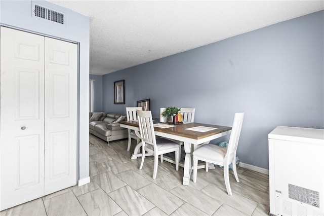 dining area with a textured ceiling