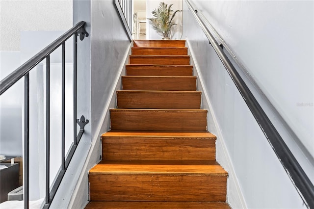 stairs with a textured ceiling