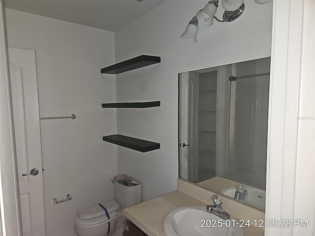 bathroom with vanity, toilet, and walk in shower