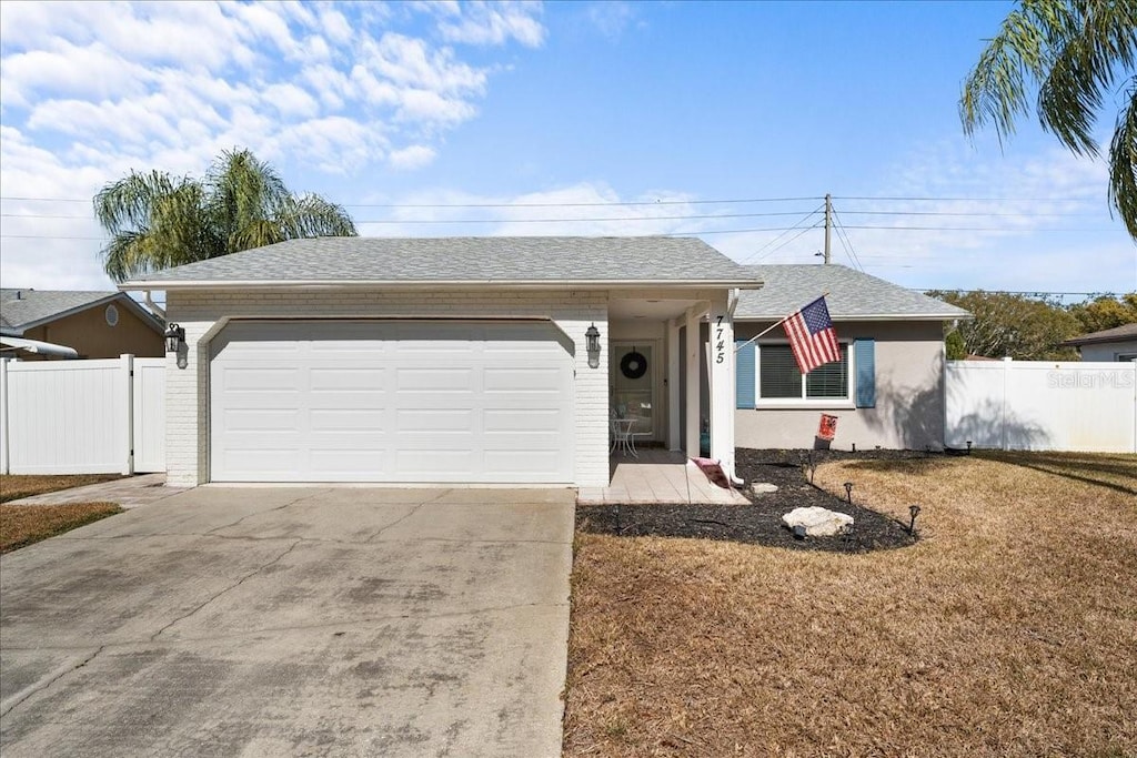 view of front of house with a garage and a front lawn