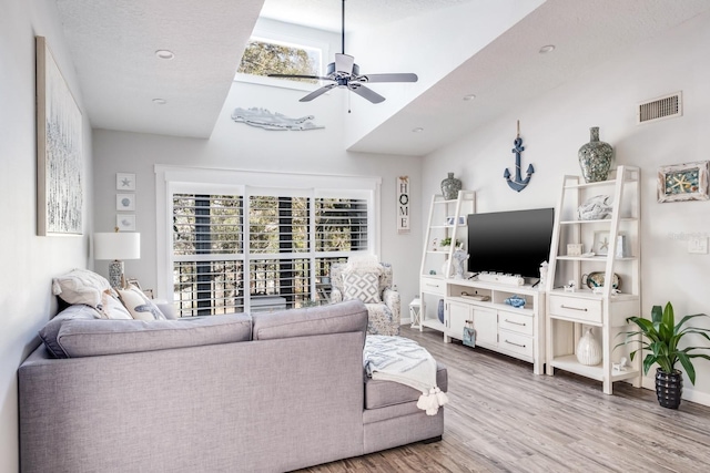 living room featuring hardwood / wood-style flooring and ceiling fan