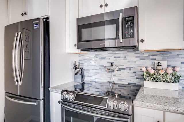 kitchen featuring white cabinetry, tasteful backsplash, and stainless steel appliances