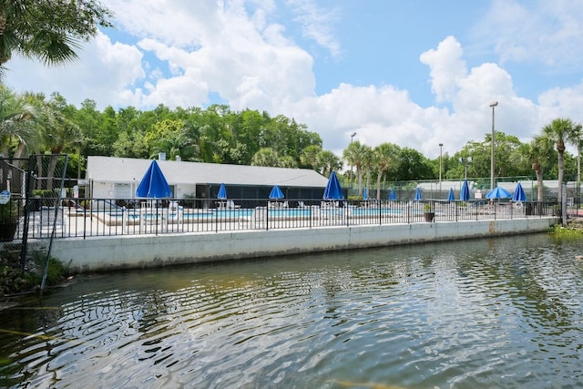 exterior space with a water view and a community pool