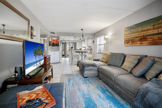 living room with sink, a textured ceiling, and light tile patterned floors