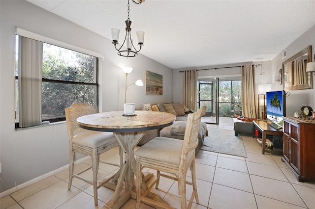 tiled dining area featuring an inviting chandelier