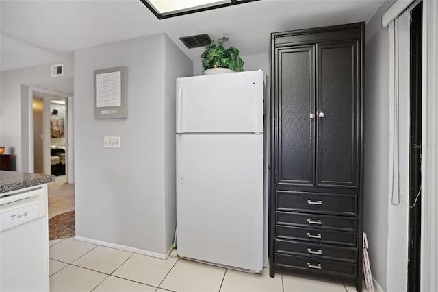 kitchen featuring light tile patterned floors and white appliances