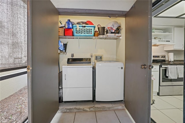 laundry area featuring light tile patterned flooring and washer and dryer