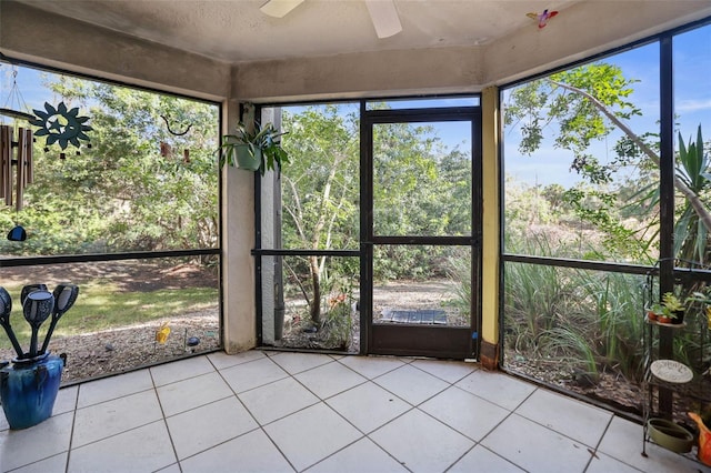 unfurnished sunroom with ceiling fan and plenty of natural light