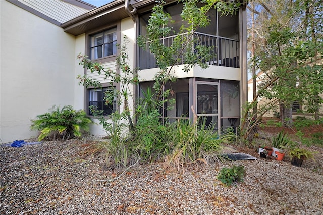 rear view of property with a sunroom