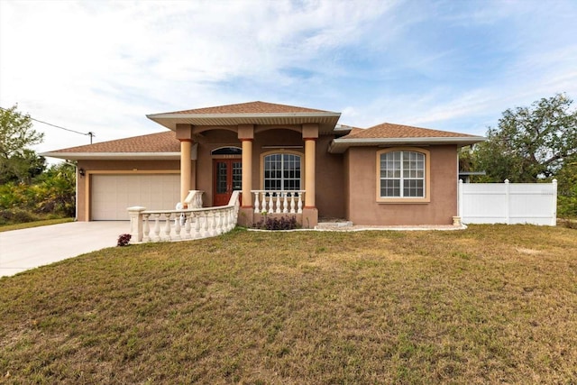 view of front of house featuring a porch, a garage, and a front lawn