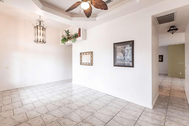 unfurnished room featuring crown molding, ceiling fan with notable chandelier, and a raised ceiling