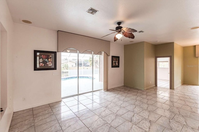 spare room with a healthy amount of sunlight and ceiling fan