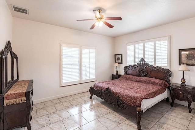 bedroom with multiple windows and ceiling fan