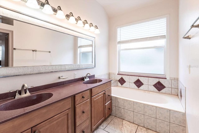 bathroom with vanity and tiled bath