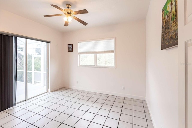 spare room featuring ceiling fan, plenty of natural light, and light tile patterned floors