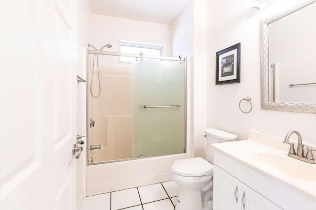 full bathroom featuring tile patterned flooring, vanity, enclosed tub / shower combo, and toilet