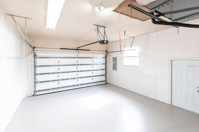 garage featuring a garage door opener and electric panel