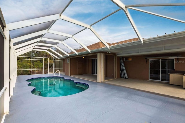 view of swimming pool with a lanai and a patio area