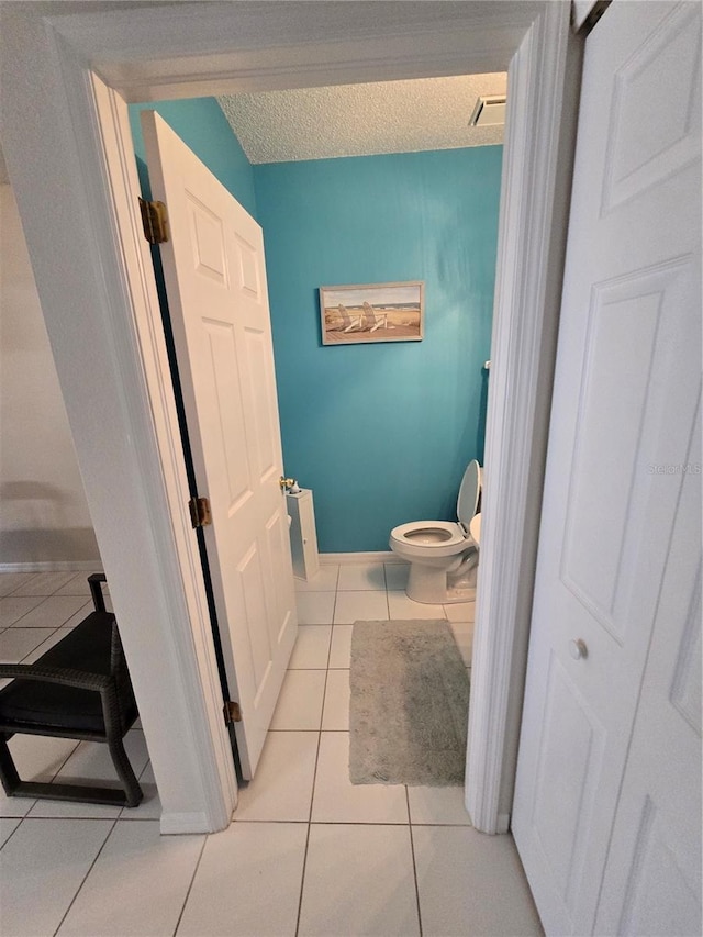 bathroom with tile patterned flooring and toilet