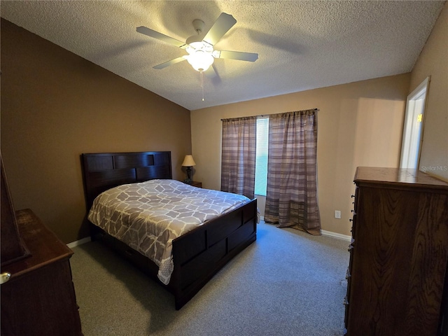 bedroom featuring ceiling fan, light carpet, and a textured ceiling