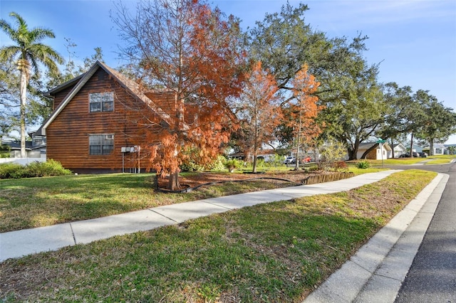 view of side of home featuring a yard