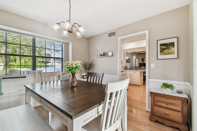 dining room with a notable chandelier and light hardwood / wood-style floors