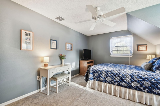 bedroom with ceiling fan, lofted ceiling, light carpet, and a textured ceiling