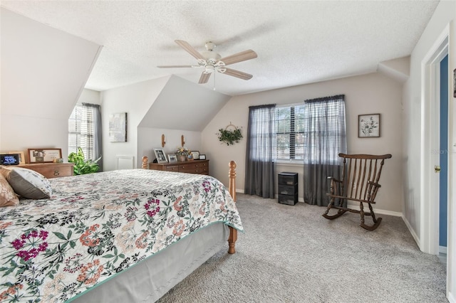 carpeted bedroom featuring ceiling fan, vaulted ceiling, and a textured ceiling