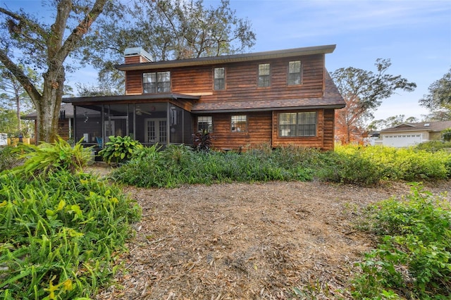 back of house featuring a sunroom